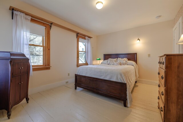 6 Sea St, Northeast Harbor, Mount Desert, ME 04662 - bedroom with multiple windows, baseboards, and light wood finished floors