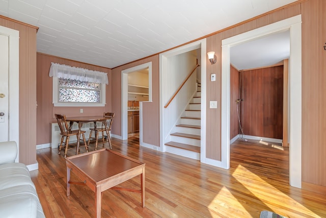 6 Sea St, Northeast Harbor, Mount Desert, ME 04662 - living room featuring stairs, light wood-type flooring, baseboards, and crown molding