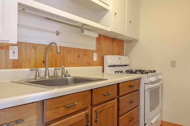 6 Sea St, Northeast Harbor, Mount Desert, ME 04662 - kitchen with white range with gas cooktop, a sink, light countertops, white cabinets, and brown cabinets