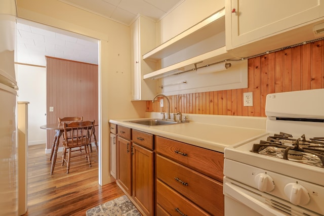 6 Sea St, Northeast Harbor, Mount Desert, ME 04662 - kitchen with white range with gas cooktop, a sink, light wood-style flooring, open shelves, and light countertops