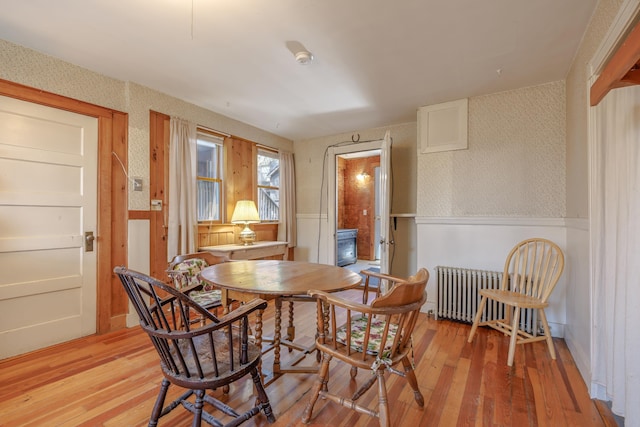 6 Sea St, Northeast Harbor, Mount Desert, ME 04662 - dining area featuring radiator, a wainscoted wall, wallpapered walls, and light wood-style flooring