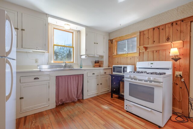 6 Sea St, Northeast Harbor, Mount Desert, ME 04662 - kitchen with white appliances, healthy amount of natural light, light wood finished floors, and wooden walls
