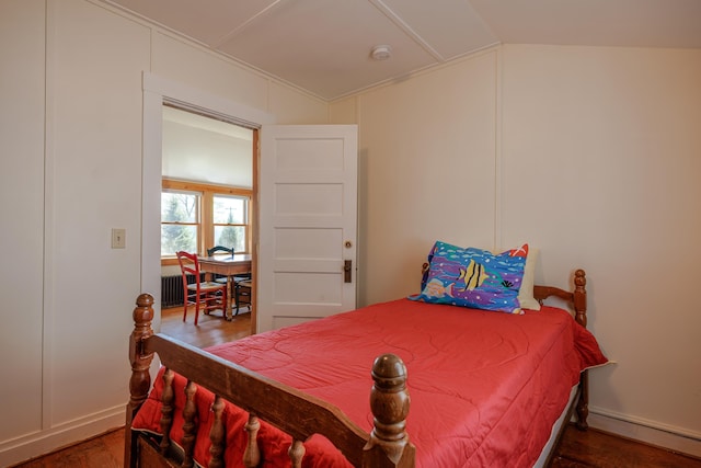6 Sea St, Northeast Harbor, Mount Desert, ME 04662 - bedroom with baseboard heating, wood finished floors, vaulted ceiling, and baseboards