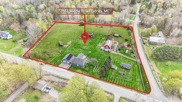 aerial view of property and surrounding area featuring property parcel outlined
