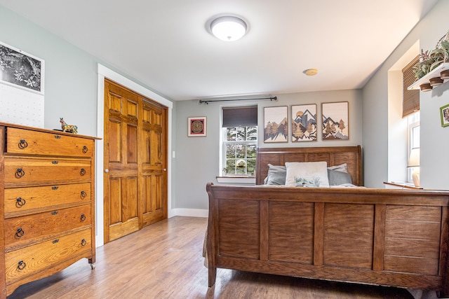 bedroom featuring light wood-style flooring and baseboards