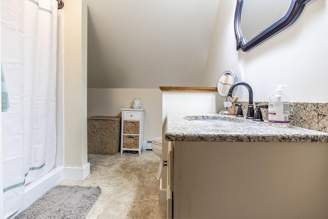 full bath featuring a stall shower, vanity, toilet, lofted ceiling, and baseboard heating