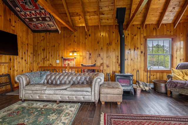 living room featuring a wood stove, beam ceiling, wood-type flooring, wood ceiling, and wooden walls