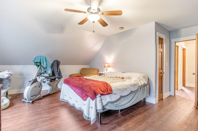 bedroom with wood finished floors, lofted ceiling, ceiling fan, and baseboards