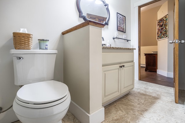bathroom with vanity, toilet, baseboards, and baseboard heating