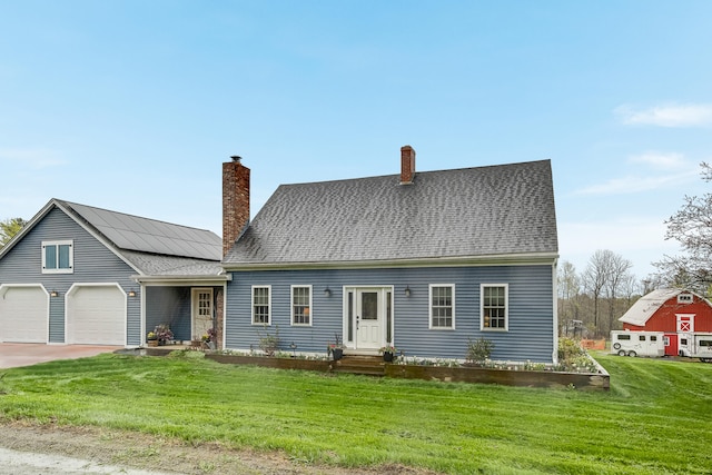 cape cod-style house with a chimney, a front yard, a garage, concrete driveway, and a shingled roof
