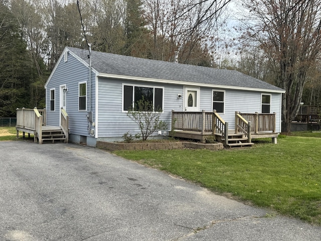 29 Faith St, Lisbon, ME 04252 - ranch-style home with roof with shingles, a wooden deck, and a front yard
