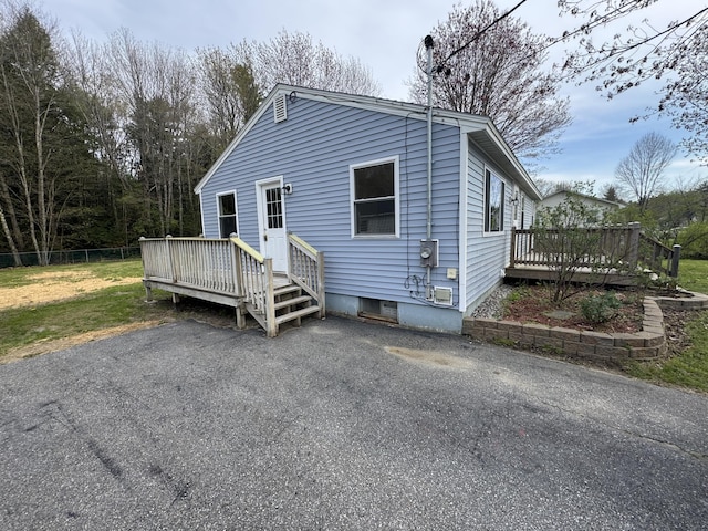 29 Faith St, Lisbon, ME 04252 - view of front of property featuring a wooden deck, fence, and a patio area