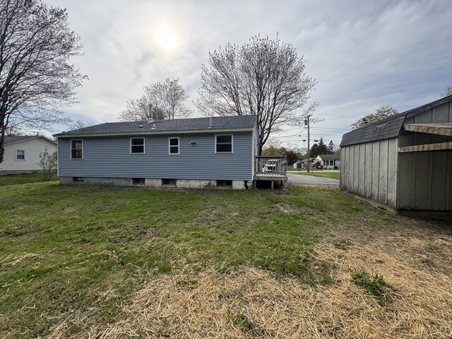 29 Faith St, Lisbon, ME 04252 - rear view of house with a lawn, an outdoor structure, and a storage shed