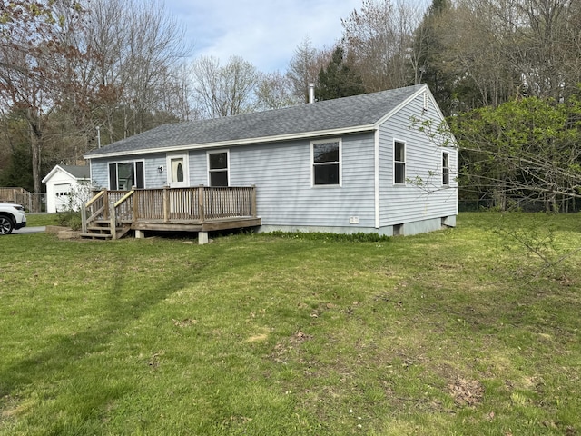 29 Faith St, Lisbon, ME 04252 - view of front of home featuring a deck, a front yard, a shingled roof, and an outbuilding