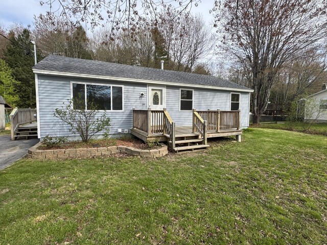 29 Faith St, Lisbon, ME 04252 - ranch-style home featuring a deck, a front lawn, and roof with shingles
