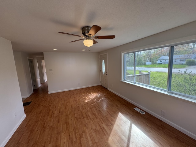 29 Faith St, Lisbon, ME 04252 - unfurnished room with wood finished floors, baseboards, a ceiling fan, and recessed lighting