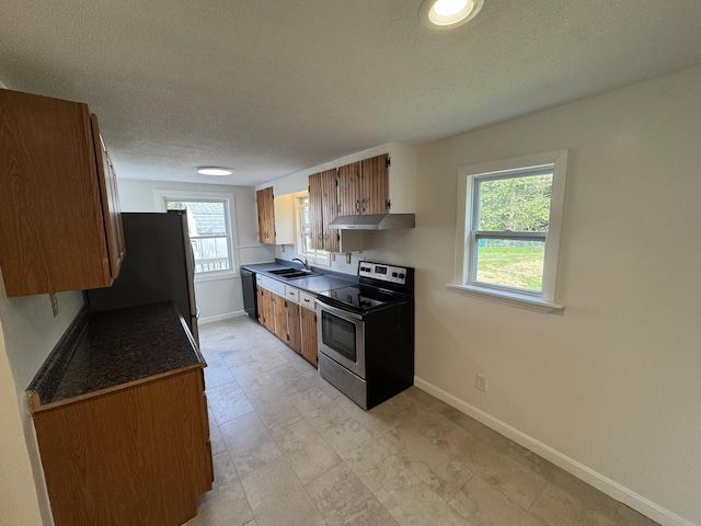 29 Faith St, Lisbon, ME 04252 - kitchen with stainless steel appliances, a sink, baseboards, plenty of natural light, and a textured ceiling