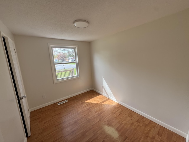 29 Faith St, Lisbon, ME 04252 - unfurnished bedroom featuring light wood-style floors, baseboards, and a textured ceiling