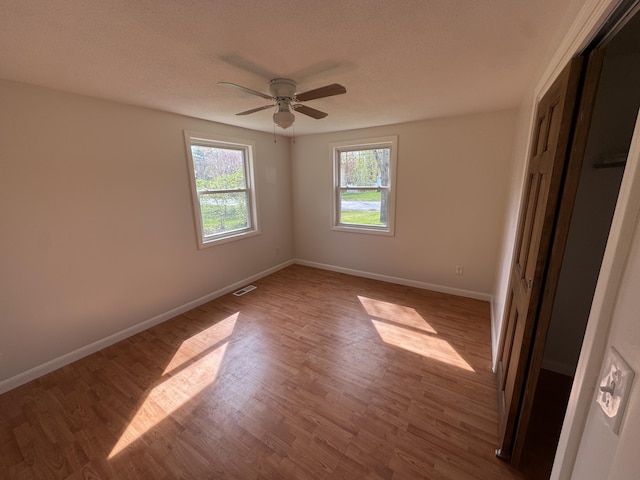29 Faith St, Lisbon, ME 04252 - unfurnished bedroom featuring a closet, wood finished floors, baseboards, and ceiling fan