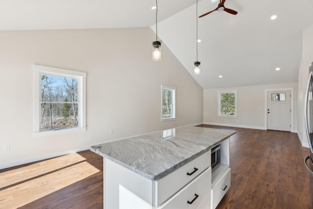 1540 Foxes Ridge Rd, Acton, ME 04001 - kitchen with open floor plan, white cabinetry, light stone countertops, dark wood-type flooring, and hanging light fixtures