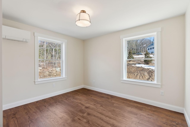 1540 Foxes Ridge Rd, Acton, ME 04001 - spare room with a wall mounted air conditioner, dark wood-style floors, and baseboards