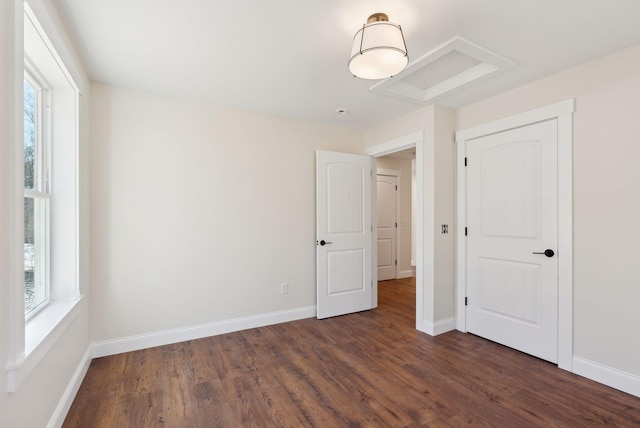 1540 Foxes Ridge Rd, Acton, ME 04001 - unfurnished bedroom featuring dark wood-style floors, multiple windows, and baseboards