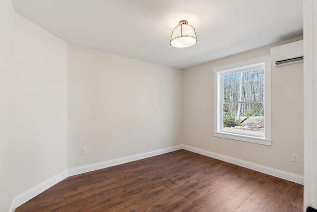 1540 Foxes Ridge Rd, Acton, ME 04001 - spare room with a wall mounted AC, dark wood-style flooring, and baseboards