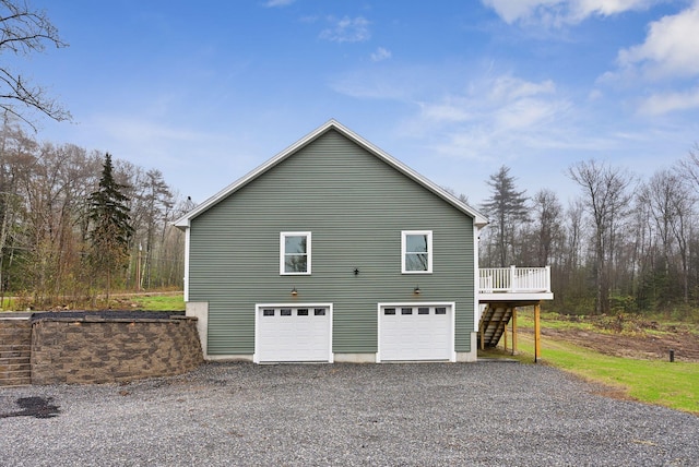 1540 Foxes Ridge Rd, Acton, ME 04001 - view of property exterior featuring stairs, a wooden deck, driveway, and a garage