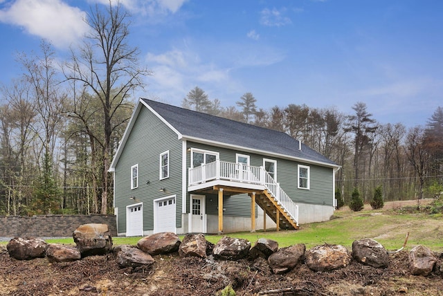 1540 Foxes Ridge Rd, Acton, ME 04001 - view of front facade with stairway, a wooden deck, a garage, and a front lawn