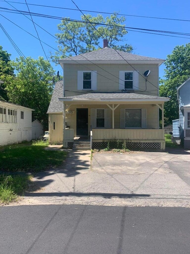 91 Elm St, Millinocket, ME 04462 - view of front of property with covered porch, roof with shingles, and a chimney