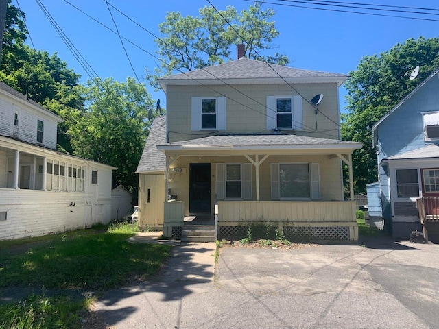 91 Elm St, Millinocket, ME 04462 - view of front facade with roof with shingles, a porch, and a chimney