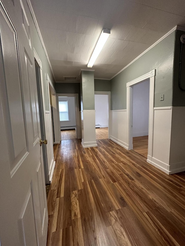 91 Elm St, Millinocket, ME 04462 - unfurnished room with crown molding, dark wood finished floors, a baseboard heating unit, and wainscoting