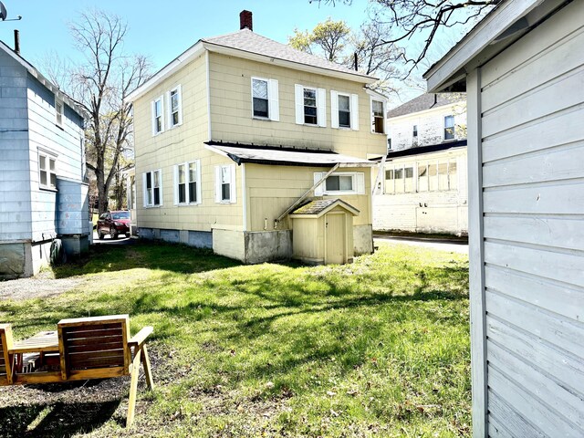 91 Elm St, Millinocket, ME 04462 - back of house with a chimney, a yard, and roof with shingles