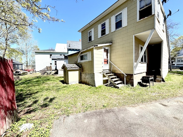 91 Elm St, Millinocket, ME 04462 - rear view of property featuring entry steps and a lawn