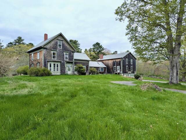 99 W Hamlet Rd, Newcastle, ME 04553 - rear view of house with a chimney and a lawn