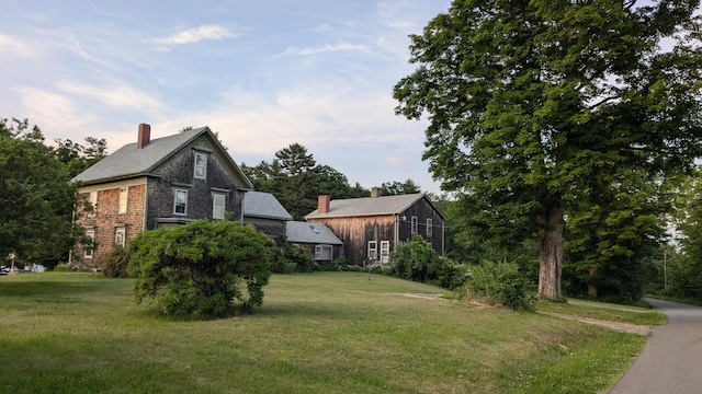 99 W Hamlet Rd, Newcastle, ME 04553 - view of side of home featuring a yard and a chimney
