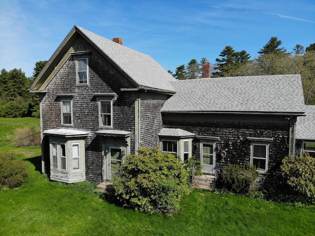 99 W Hamlet Rd, Newcastle, ME 04553 - view of front of home featuring a chimney, a front lawn, and a shingled roof