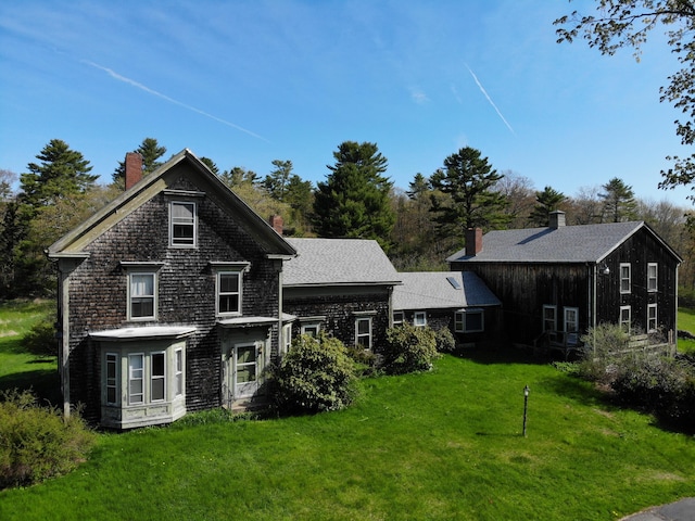 99 W Hamlet Rd, Newcastle, ME 04553 - rear view of property featuring a lawn and a chimney