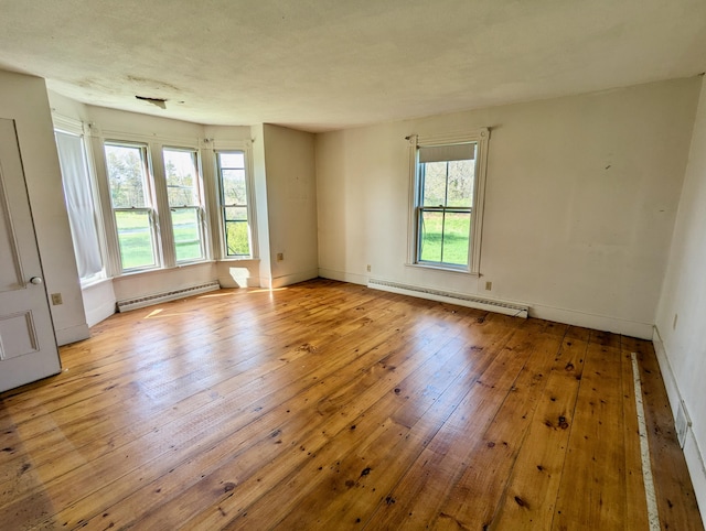 99 W Hamlet Rd, Newcastle, ME 04553 - empty room with a baseboard heating unit, light wood finished floors, and baseboards