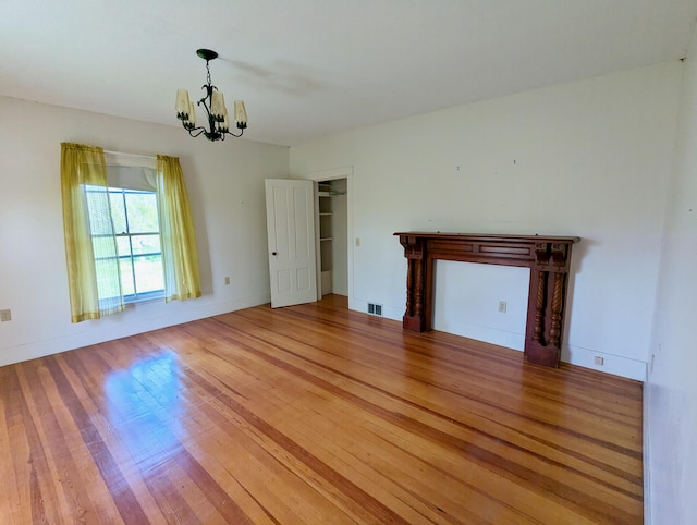 99 W Hamlet Rd, Newcastle, ME 04553 - unfurnished room featuring a chandelier, light wood finished floors, and baseboards