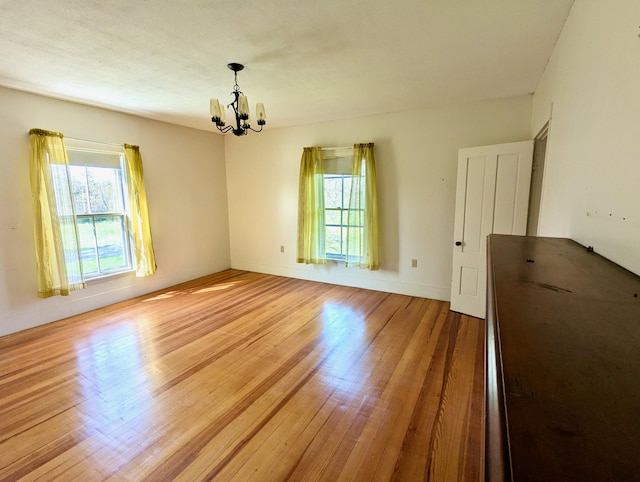 99 W Hamlet Rd, Newcastle, ME 04553 - unfurnished room featuring a chandelier and light wood-style floors