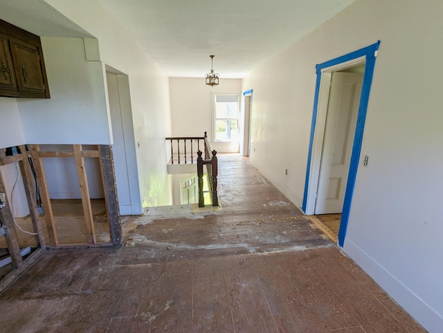 99 W Hamlet Rd, Newcastle, ME 04553 - corridor with baseboards, an upstairs landing, a chandelier, and wood finished floors