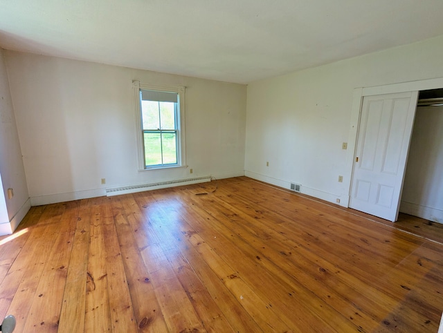 99 W Hamlet Rd, Newcastle, ME 04553 - unfurnished room with a baseboard radiator, wood-type flooring, and baseboards