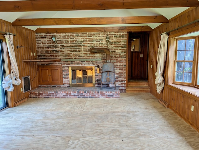 99 W Hamlet Rd, Newcastle, ME 04553 - unfurnished living room with wood walls, heating unit, a wood stove, and a baseboard heating unit