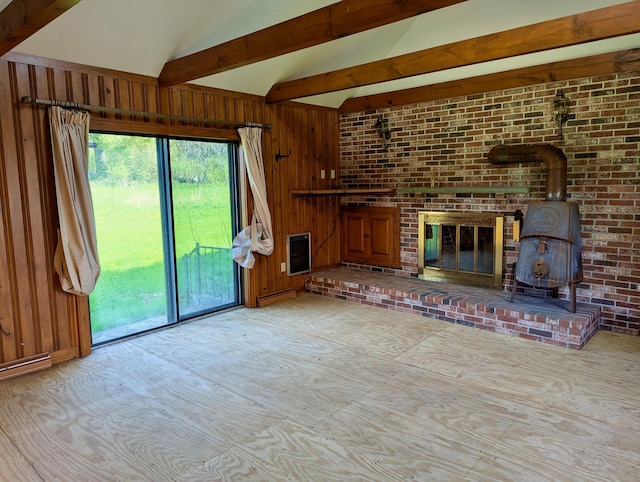 99 W Hamlet Rd, Newcastle, ME 04553 - unfurnished living room with a baseboard heating unit, wooden walls, heating unit, and a wood stove
