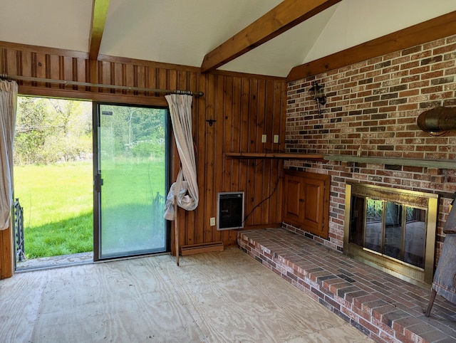 99 W Hamlet Rd, Newcastle, ME 04553 - unfurnished living room featuring heating unit, wooden walls, and a brick fireplace