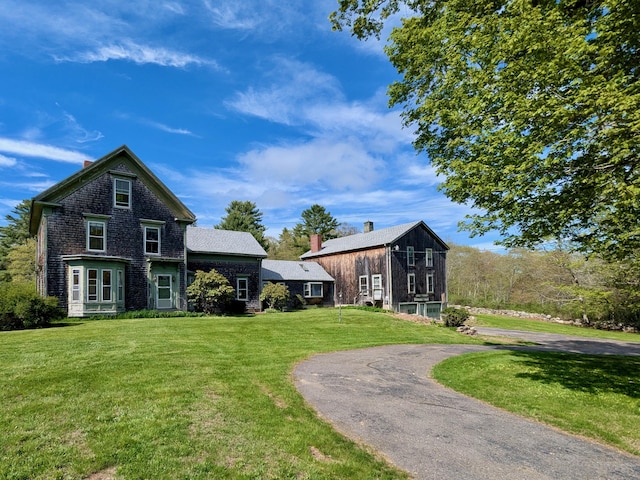 99 W Hamlet Rd, Newcastle, ME 04553 - view of front of house with a front lawn, a chimney, and driveway
