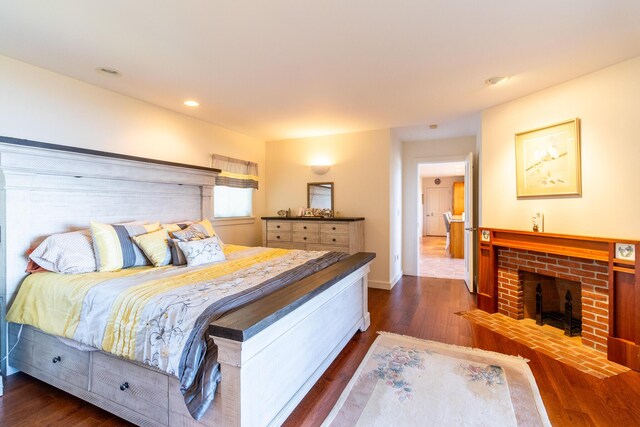 372 Pettegrow Point Rd, Machiasport, ME 04655 - bedroom featuring a brick fireplace, dark wood finished floors, recessed lighting, and baseboards