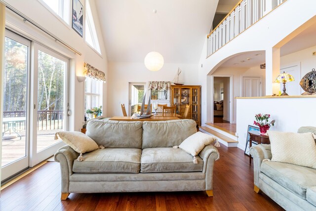 372 Pettegrow Point Rd, Machiasport, ME 04655 - living room featuring a towering ceiling, dark wood-style floors, and arched walkways