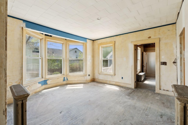 244 Concord St W, Portland, ME 04103 - empty room featuring radiator heating unit, healthy amount of natural light, wood finished floors, baseboards, and ornamental molding